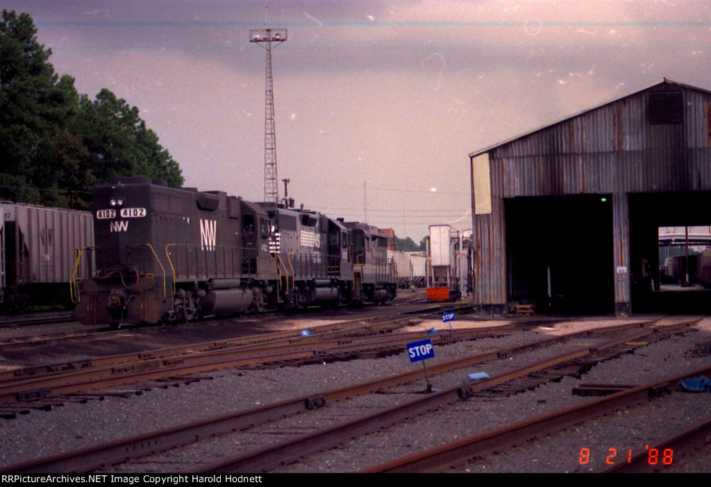 NW 4102 sits with an NS and Southern unit, beside the Engine House
